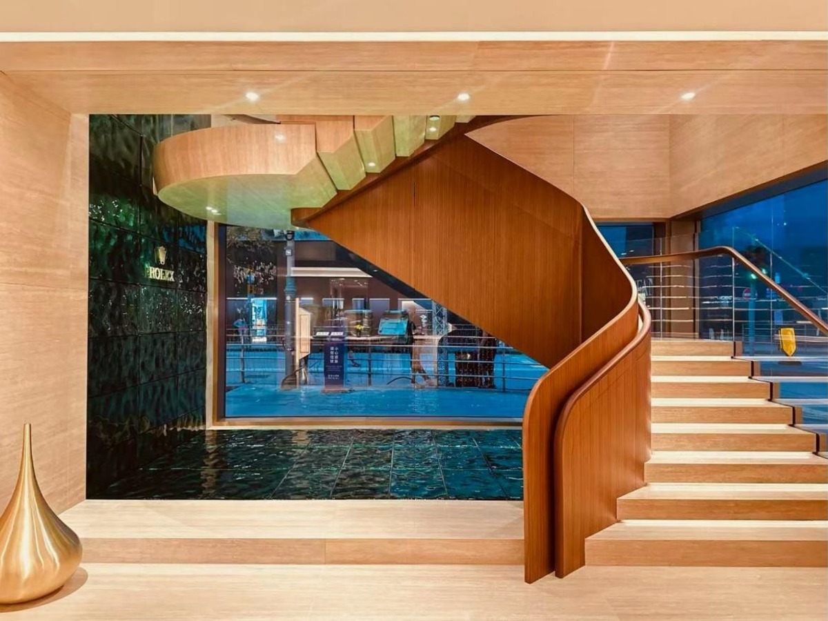 Geschwungene Holztreppe im Eingangsbereich der Rolex-Boutique von Bucherer in Hongkong